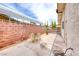 Home's backyard features a brick wall, a patio, and a green backyard at 1120 Mariposa Way, Boulder City, NV 89005