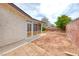 Home's backyard features a brick wall, a screened in patio, and a tree at 1120 Mariposa Way, Boulder City, NV 89005