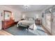 Bright primary bedroom featuring hardwood floors, bench, and backyard access at 1120 Mariposa Way, Boulder City, NV 89005