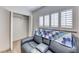 Relaxing bedroom features a closet, wood-look floors, and a comfy couch at 1120 Mariposa Way, Boulder City, NV 89005