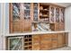 Detailed view of custom cabinetry with glass display cases, wine storage, and elegant countertops at 1120 Mariposa Way, Boulder City, NV 89005