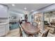 Dining area leading to the sunroom, connecting to the living room and kitchen for an open floor plan at 1120 Mariposa Way, Boulder City, NV 89005