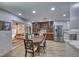 Bright dining area featuring wood floors, custom cabinetry, and an adjacent living area, great for entertaining at 1120 Mariposa Way, Boulder City, NV 89005