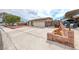 Charming single-story home featuring a well-maintained front yard and an attached two-car garage at 1120 Mariposa Way, Boulder City, NV 89005