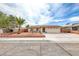 Charming single-story home featuring a well-maintained front yard and an attached two-car garage at 1120 Mariposa Way, Boulder City, NV 89005