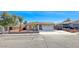 Charming single-story home featuring a well-maintained front yard and attached two-car garage at 1120 Mariposa Way, Boulder City, NV 89005
