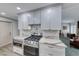Bright kitchen featuring stainless steel appliances, white cabinetry, and modern countertops at 1120 Mariposa Way, Boulder City, NV 89005