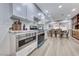 Open-concept kitchen with stainless steel appliances, custom cabinets, and a view into the dining area at 1120 Mariposa Way, Boulder City, NV 89005