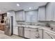 Well-lit kitchen showcasing stainless steel appliances, custom cabinets, and stylish countertops for a modern feel at 1120 Mariposa Way, Boulder City, NV 89005