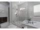 Stylish bathroom with a glass-enclosed shower, soaking tub, and granite countertops at 13 Porto Malaga St, Henderson, NV 89011