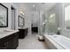 Luxurious bathroom featuring a soaking tub, glass-enclosed shower, and dual vanities at 13 Porto Malaga St, Henderson, NV 89011