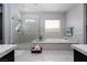 Elegant bathroom with a large shower, soaking tub, and modern fixtures at 13 Porto Malaga St, Henderson, NV 89011