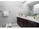 Well-lit bathroom featuring a large mirror, vanity, and essential amenities at 13 Porto Malaga St, Henderson, NV 89011