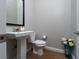 Stylish half-bathroom featuring a pedestal sink, modern fixtures, and neutral wall tones at 13 Porto Malaga St, Henderson, NV 89011