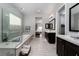 Spacious bathroom with a soaking tub, glass shower, dual sinks, and modern design at 13 Porto Malaga St, Henderson, NV 89011
