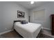 Bedroom with white comforter and a picture on the wall at 13 Porto Malaga St, Henderson, NV 89011