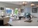 Bright dining area with large sliding glass doors, modern light fixtures, and comfortable seating at 13 Porto Malaga St, Henderson, NV 89011