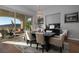 Elegant dining area with a dark wood table, upholstered chairs, and a modern chandelier at 13 Porto Malaga St, Henderson, NV 89011