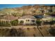 Scenic aerial view of a home showcasing its backyard pool, patio with dining set, and surrounding lush greenery at 13 Porto Malaga St, Henderson, NV 89011