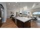 Open-concept kitchen showcasing a large island with quartz countertops and pendant lighting, with an adjacent dining area at 13 Porto Malaga St, Henderson, NV 89011