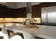 Modern kitchen features a spacious island, stainless steel appliances, and dark cabinetry at 13 Porto Malaga St, Henderson, NV 89011