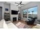 Cozy living room with a fireplace, large windows offering scenic views, and comfortable seating at 13 Porto Malaga St, Henderson, NV 89011