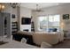Bright living room with a stone fireplace, large windows, and hardwood floors at 13 Porto Malaga St, Henderson, NV 89011
