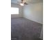 Spacious bedroom with carpet, ceiling fan, and natural light from a large window at 1607 Colloquium Dr # 0, Henderson, NV 89014