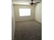 Well-lit bedroom featuring carpet, ceiling fan, and large window for natural light at 1607 Colloquium Dr # 0, Henderson, NV 89014