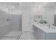 Stylish bathroom with a glass-enclosed shower, double vanity sinks, and modern finishes at 180 Native Stone St, Las Vegas, NV 89138