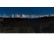 Enjoy an expansive and illuminated city view at night, overlooking neighboring rooftops at 180 Native Stone St, Las Vegas, NV 89138