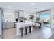 Modern kitchen featuring a central island with bar stools, stainless steel appliances, and an adjacent dining area at 180 Native Stone St, Las Vegas, NV 89138