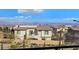 Neighborhood view from a balcony, complete with city lights and mountain peaks on the horizon at 180 Native Stone St, Las Vegas, NV 89138