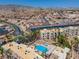 Aerial view of the community showcasing a pool, apartment buildings, and mountain views at 2048 Mesquite Ln # 303, Laughlin, NV 89029
