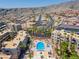An aerial view showcases the apartments, community pool, and desert landscape at 2048 Mesquite Ln # 303, Laughlin, NV 89029