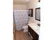 Bright bathroom with a seashell shower curtain, white sink and brown vanity at 2048 Mesquite Ln # 303, Laughlin, NV 89029
