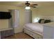 Cozy bedroom boasts a ceiling fan, mounted TV, drawers and natural light, creating a tranquil and inviting personal space at 2048 Mesquite Ln # 303, Laughlin, NV 89029