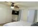 Bright bedroom featuring a ceiling fan, closet, two windows, and a wall-mounted television for relaxation and entertainment at 2048 Mesquite Ln # 303, Laughlin, NV 89029