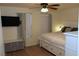 Cozy bedroom boasts a ceiling fan, mounted TV, drawers and natural light, creating a tranquil and inviting personal space at 2048 Mesquite Ln # 303, Laughlin, NV 89029