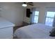 Bright bedroom featuring a ceiling fan, closet, two windows, and a wall-mounted television for relaxation and entertainment at 2048 Mesquite Ln # 303, Laughlin, NV 89029