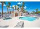 Community pool with a hot tub, lounge chairs, and palm trees at 2048 Mesquite Ln # 303, Laughlin, NV 89029
