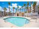 Beautiful community pool area surrounded by palm trees and condo buildings at 2048 Mesquite Ln # 303, Laughlin, NV 89029