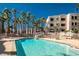 Inviting pool with spa and lounge chairs, nestled amidst apartment buildings and palm trees at 2048 Mesquite Ln # 303, Laughlin, NV 89029