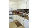 Kitchen features white appliances, wood-look flooring, and bright lighting at 2048 Mesquite Ln # 303, Laughlin, NV 89029
