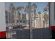 View through window blinds of palm trees and neighboring buildings across the street at 2048 Mesquite Ln # 303, Laughlin, NV 89029