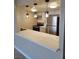 Bright kitchen with stylish pendant lighting, white cabinetry, marbled countertop, and stainless steel appliances at 205 E Harmon Ave # 212, Las Vegas, NV 89169