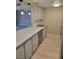 Well-lit kitchen showcasing sleek stainless steel appliances, marbled countertops, and wood grain flooring at 205 E Harmon Ave # 212, Las Vegas, NV 89169