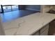 Open kitchen area with marbled countertops, stainless steel sink, and a view into the living space at 205 E Harmon Ave # 212, Las Vegas, NV 89169
