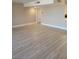 Spacious living room with wood-look flooring, neutral paint, and ample natural light creating a bright and inviting space at 205 E Harmon Ave # 212, Las Vegas, NV 89169