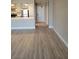 Spacious living room with wood-look flooring and neutral paint adjacent to the kitchen at 205 E Harmon Ave # 212, Las Vegas, NV 89169